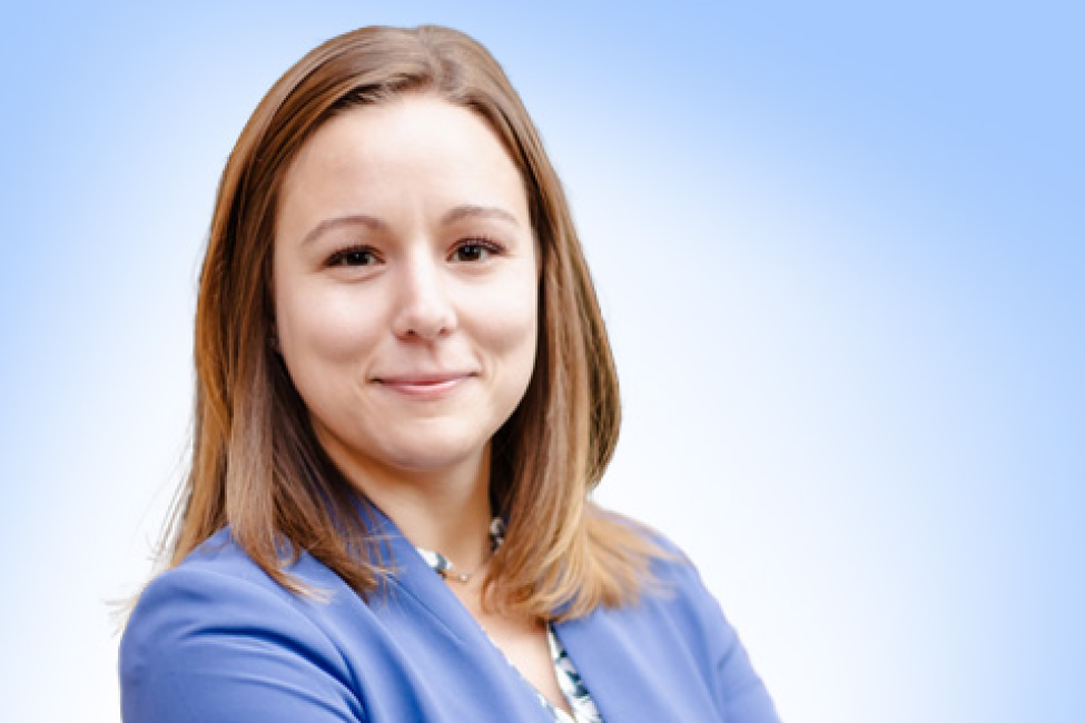 A smiling woman in a blue jacket