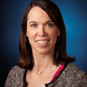 Photo of a woman with a big smile looking right at the camera