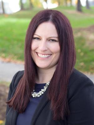 A pleasantly smiling woman in a black top