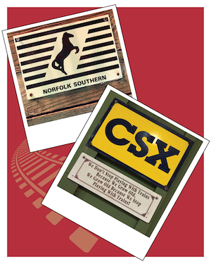Two wall placards, one with the Norfolk Southern logo, the other with the CSX logo above a sign reading "We don't stop playing with trains because we grow old, we grow old because we stop playing with trains"