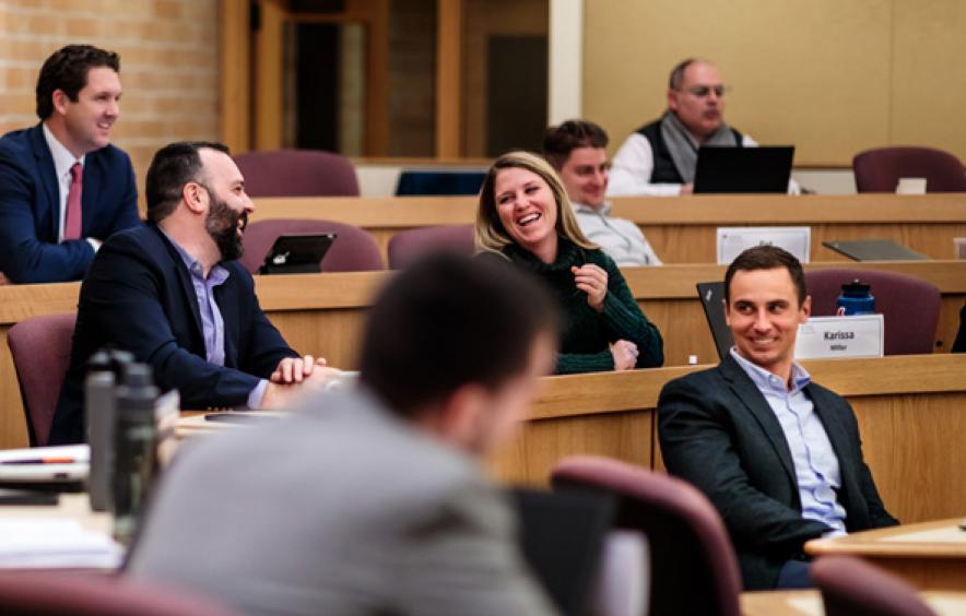 People in classroom having a discussion and laughing.