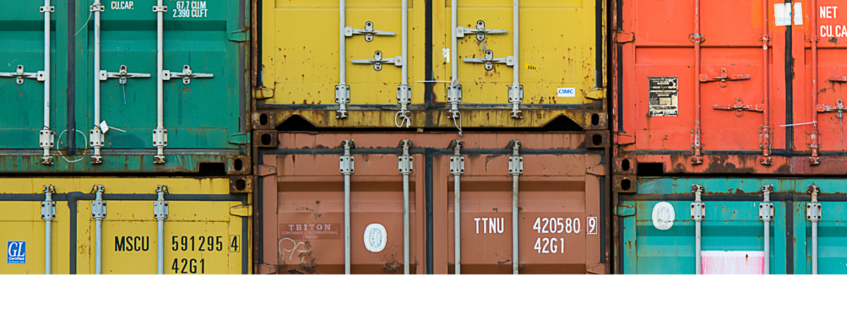 Brightly colored shipping containers stacked 3 across and 2 high.