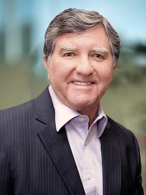 Smiling gray-haired man in a dark sports coat